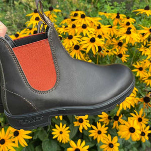 Brown Blundstone boots with orange inner lining in the garden