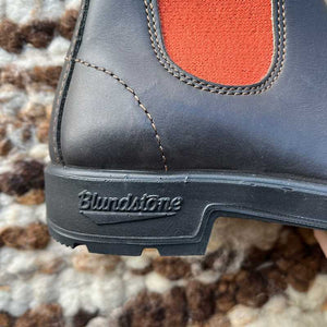 Close-up of a Blundstone boot sole with orange elastic 
