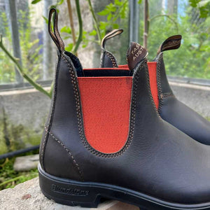Brown Blundstone boots with deep Orange lining in the outdoors. 