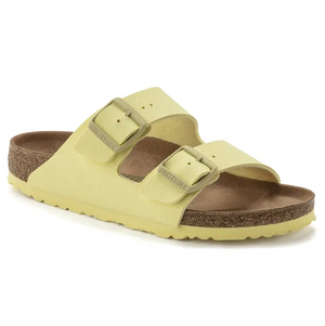 Yellow Birkenstock sandal with cork sole on a white background