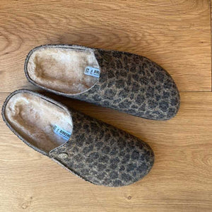 Pair of Birkenstock leopard print slippers on a wooden floor Ireland