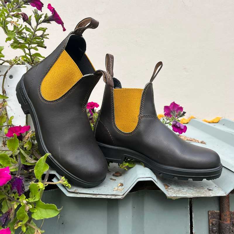 Pair of brown blundstone boots with yellow elastic 