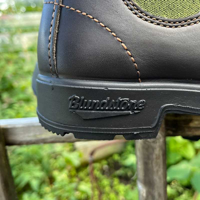 Close-up of a Blundstone boot with an olive green side panel