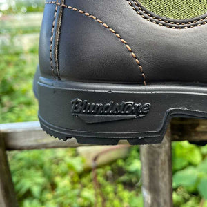 Close-up of a Blundstone boot with an olive green side panel